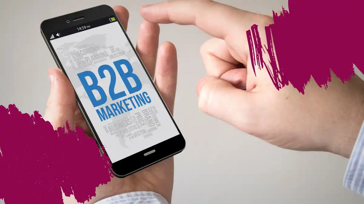 Hand holding a smartphone displaying the text 'B2B Marketing,' symbolizing digital strategies in the business world.