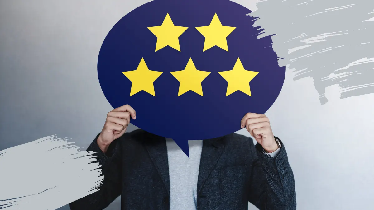 Person holding a speech bubble with five yellow stars, symbolizing customer satisfaction and trust.