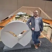 Fabio Olivetti posando junto al logotipo de Vertiv en un entorno corporativo moderno.